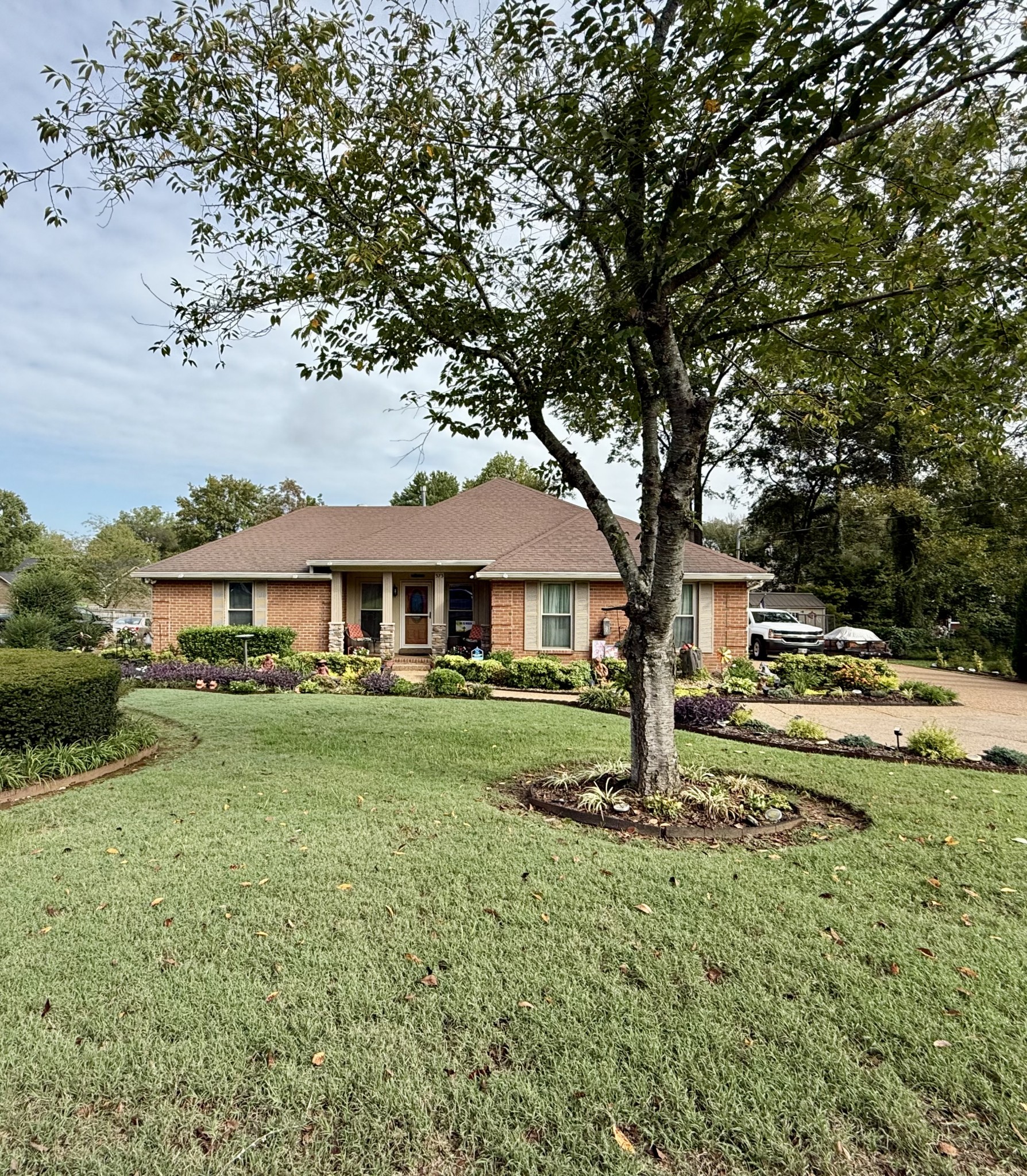 a view of a house with yard and sitting area