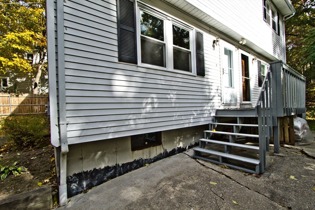 a view of a house with a yard and wooden fence