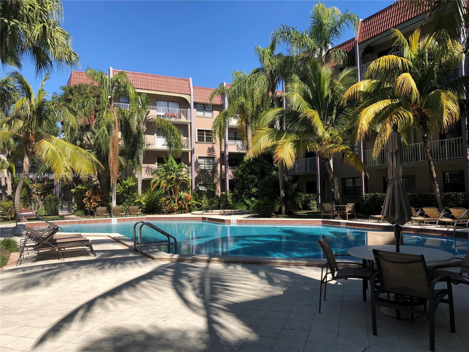 a swimming pool with outdoor seating and yard