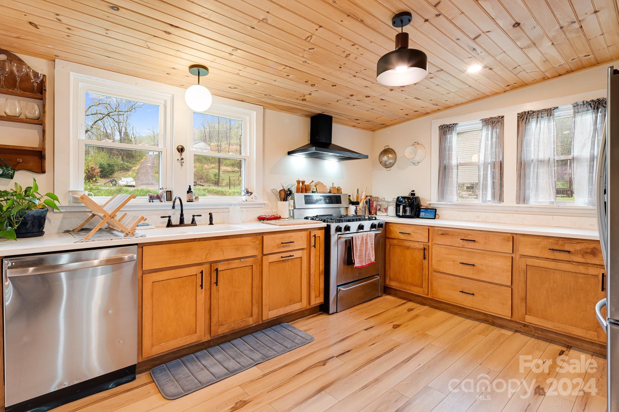 a kitchen with cabinets a sink and appliances