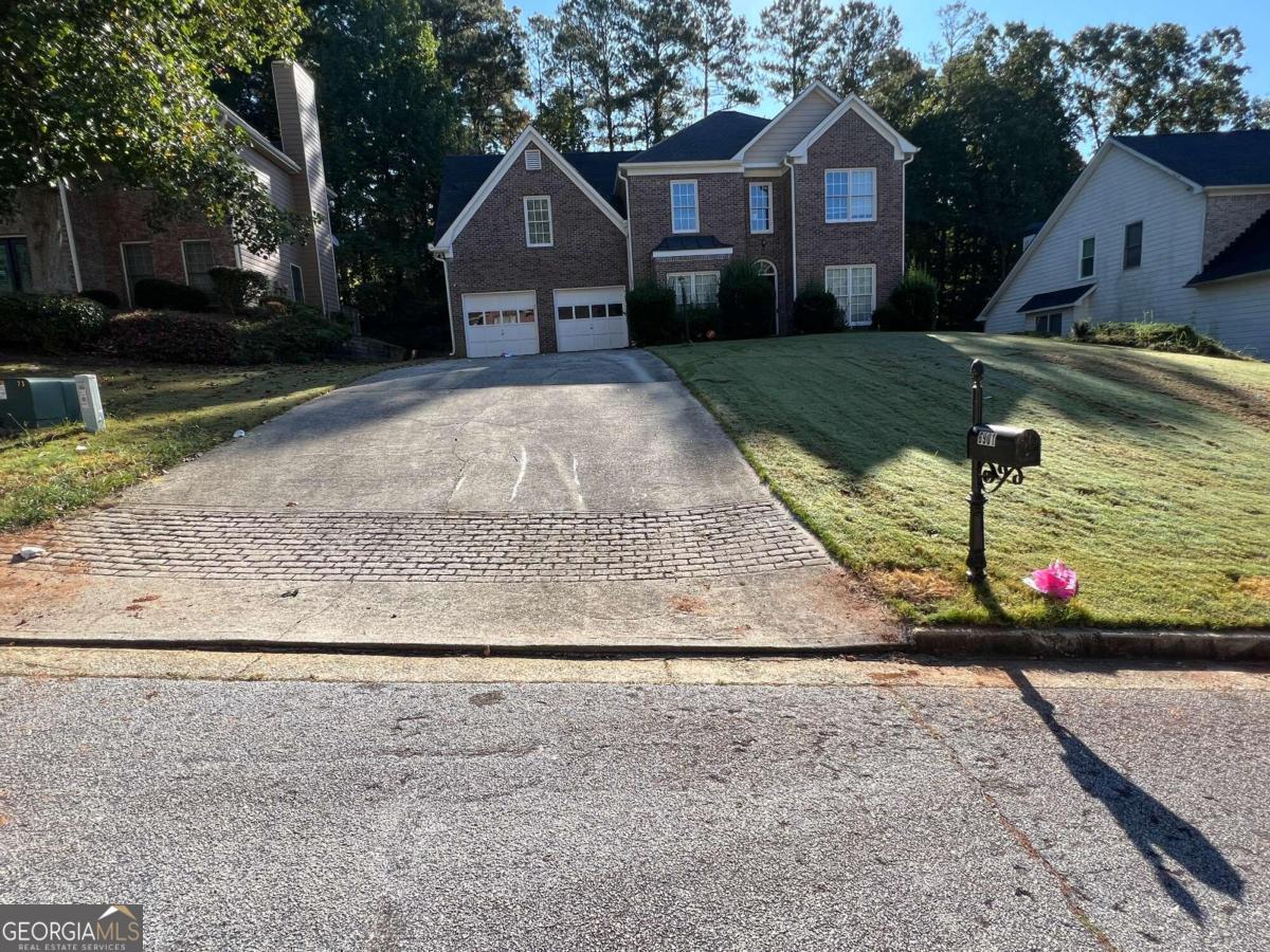 a front view of a house with a yard and garage