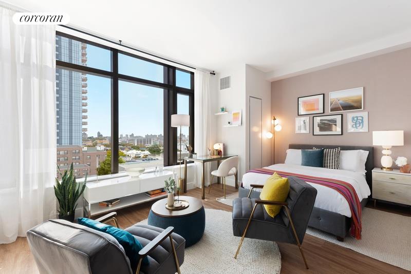 a living room with furniture and large windows