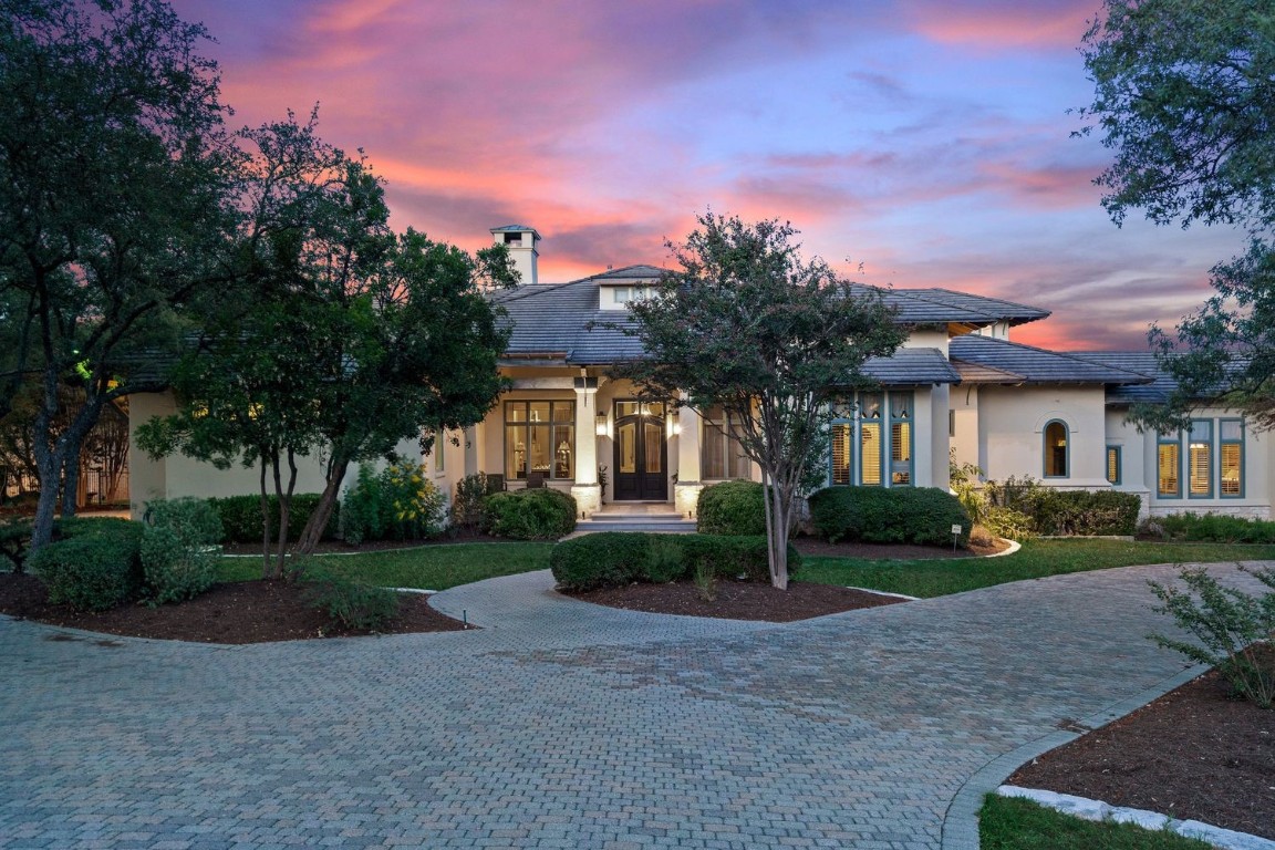 a front view of a house with a yard and a garage