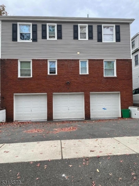 a front view of a house with a road