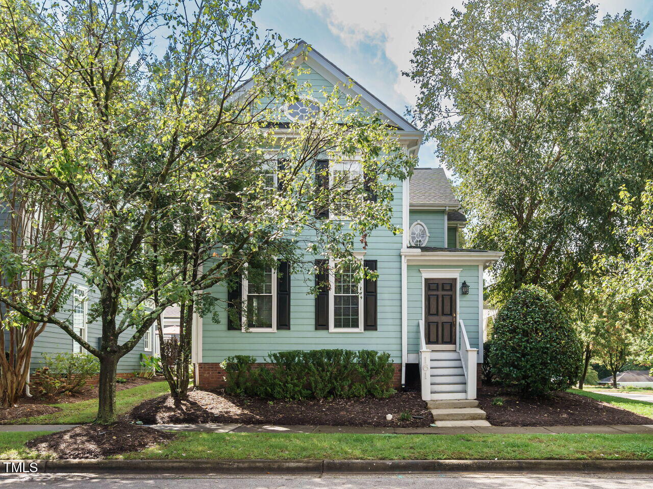 a front view of a house with a garden