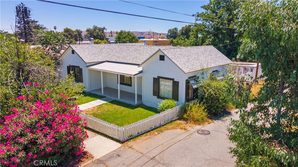 a view of a house with a yard and garden