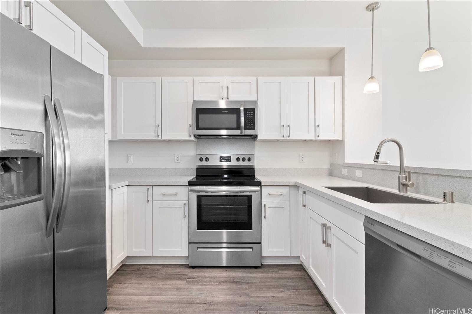 Beautiful quartz countertops, white shaker cabinets & stainless steel appliances.