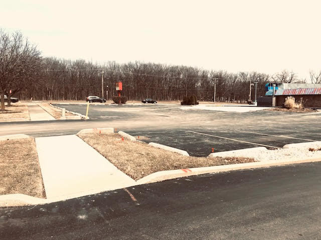 a view of houses with snow on the road