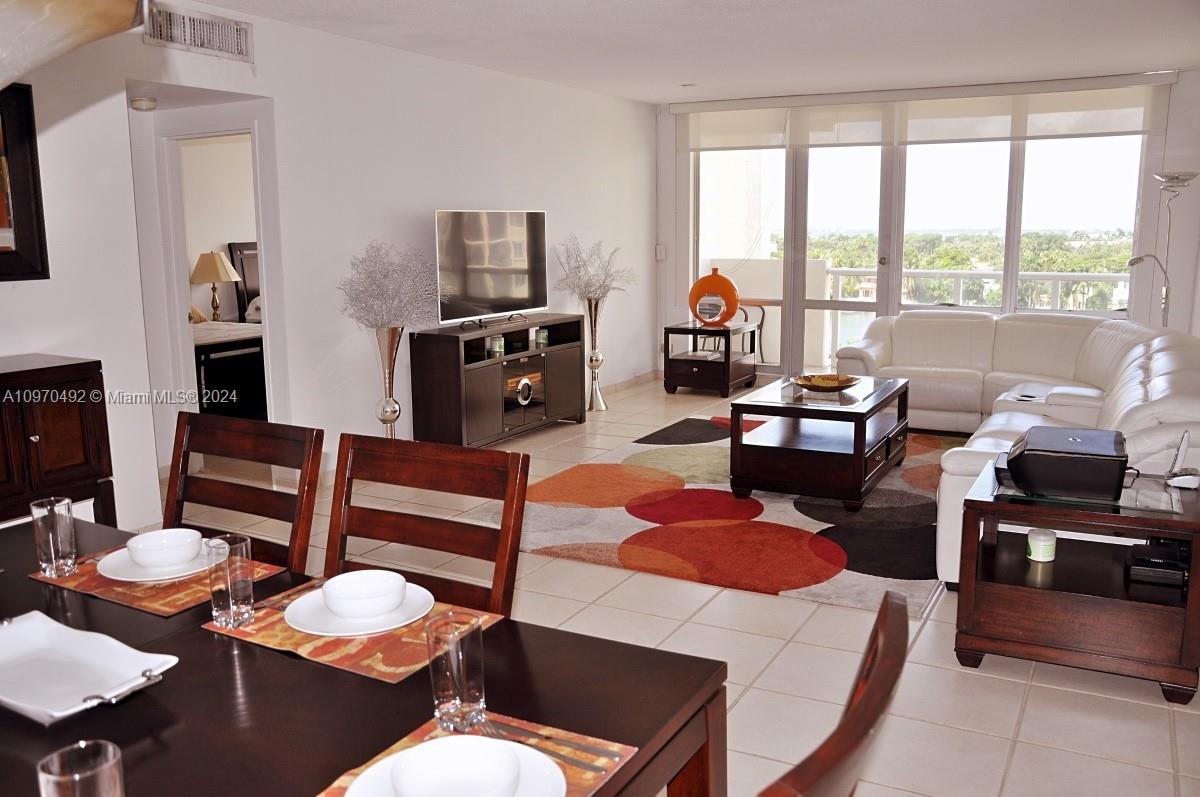 a living room with furniture fireplace and a large window