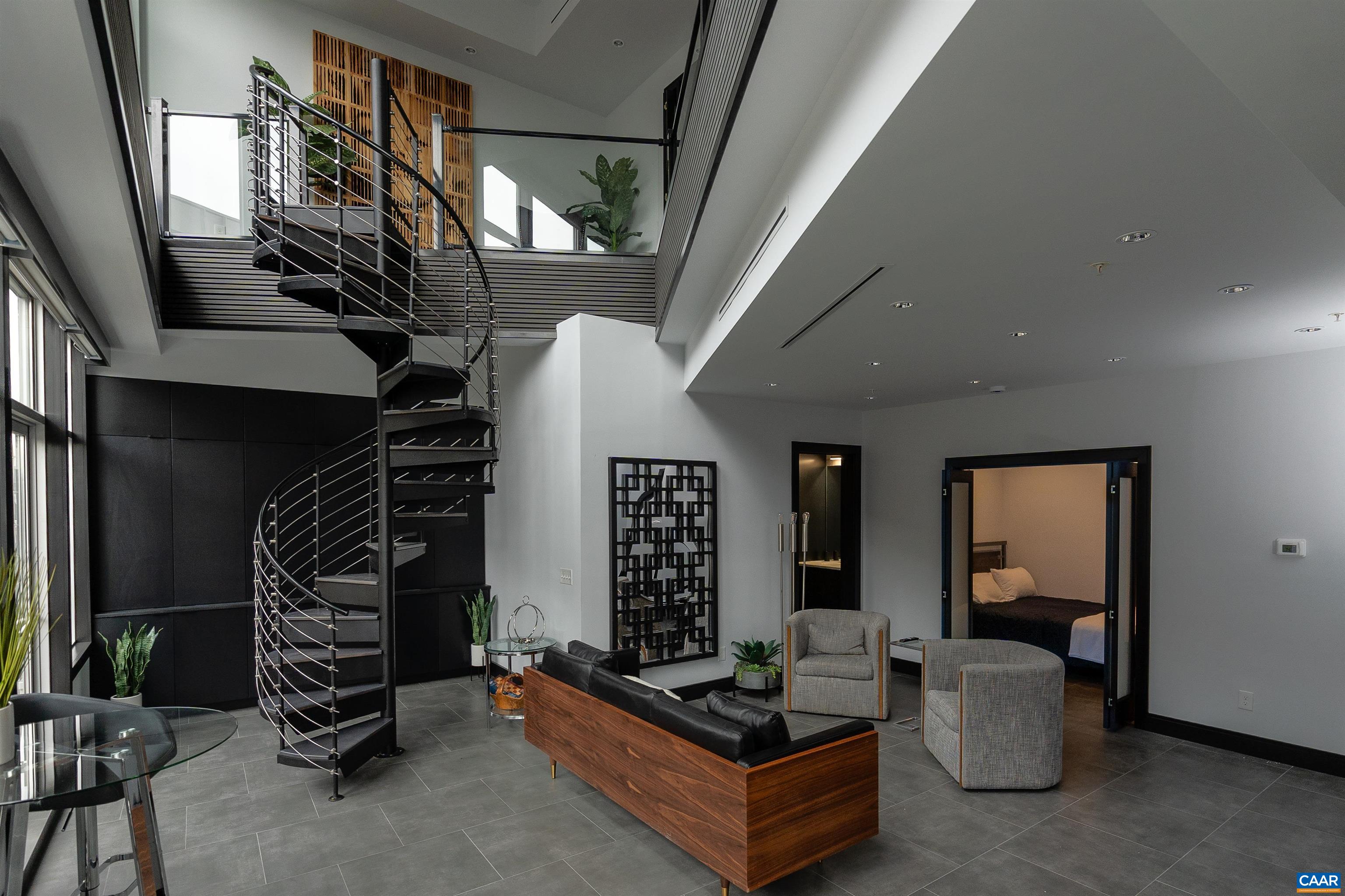 a living room with furniture and a staircase