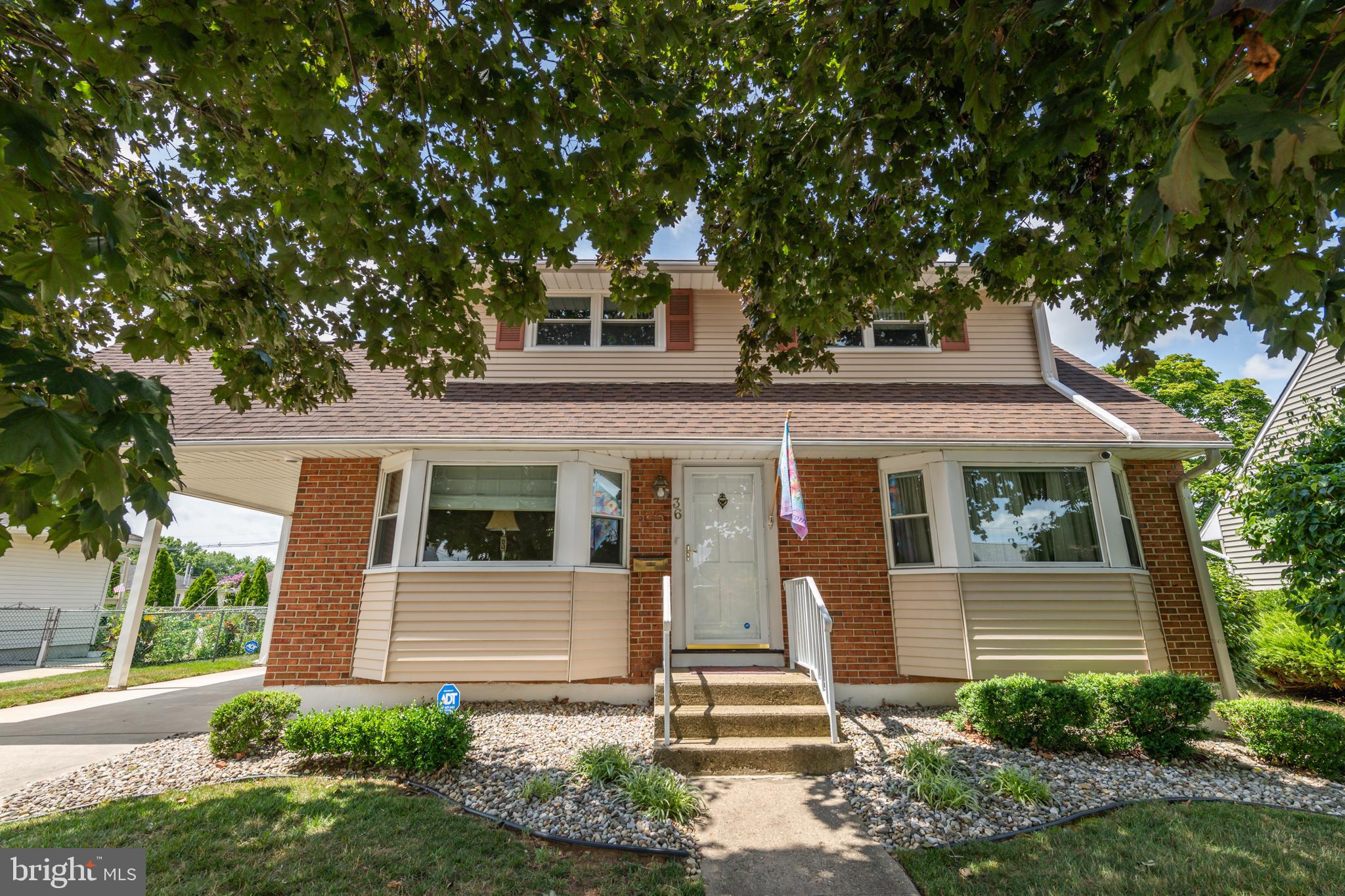 front view of a house with a tree