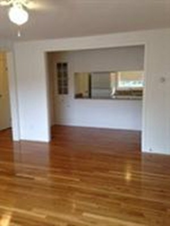 a view of room and hall with wooden floor