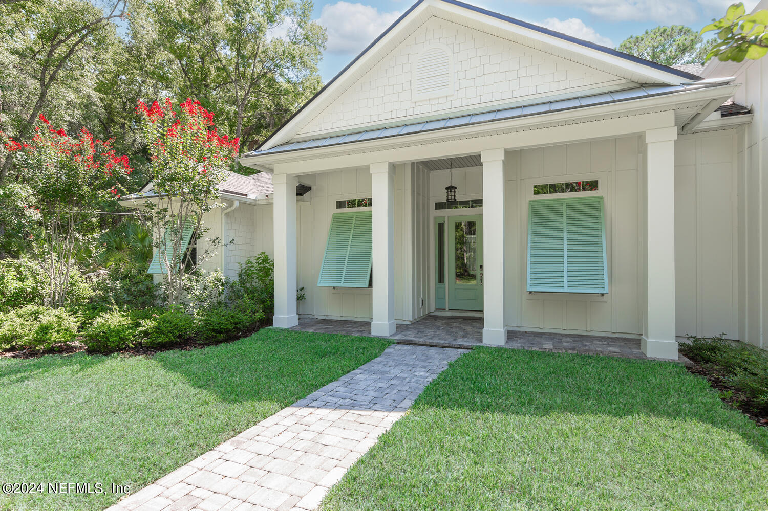 a front view of a house with a yard and porch