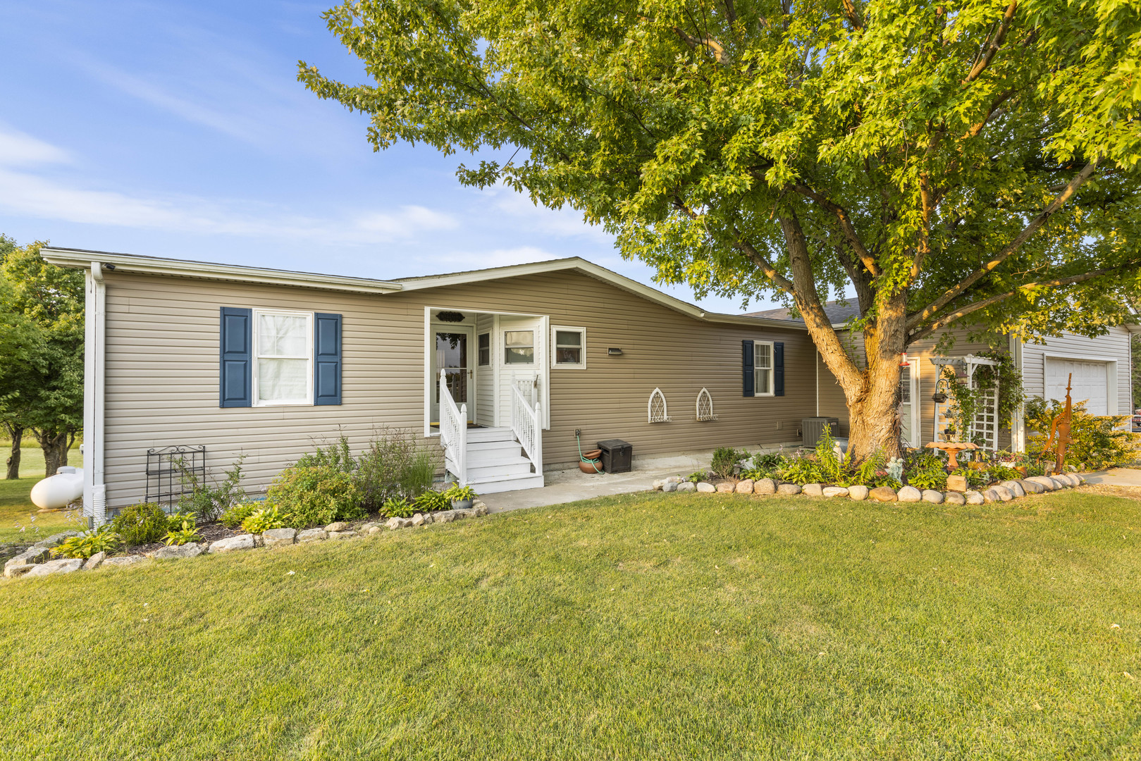 a front view of house with yard and trees around