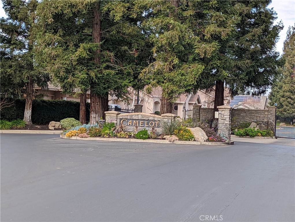 front view of a house with a street and trees