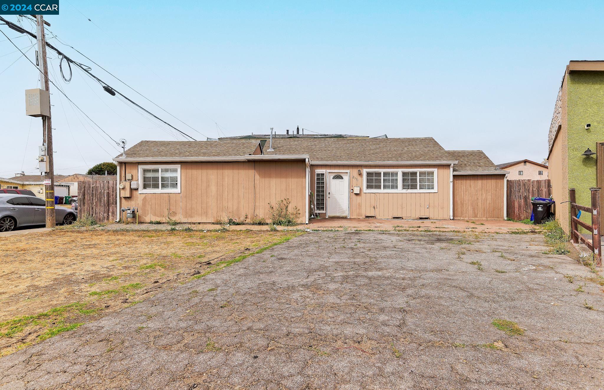 a view of a house with a wooden fence