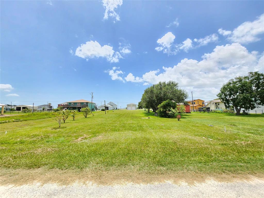 a view of a big yard with swimming pool and outdoor seating