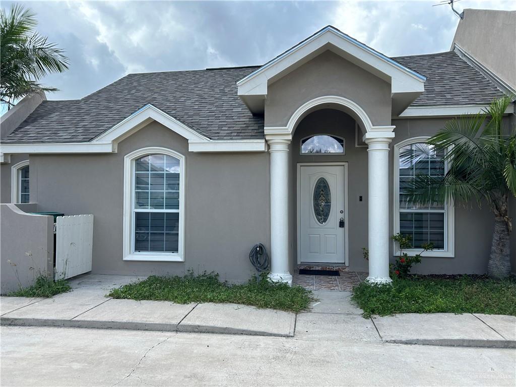 a front view of a house with a garden