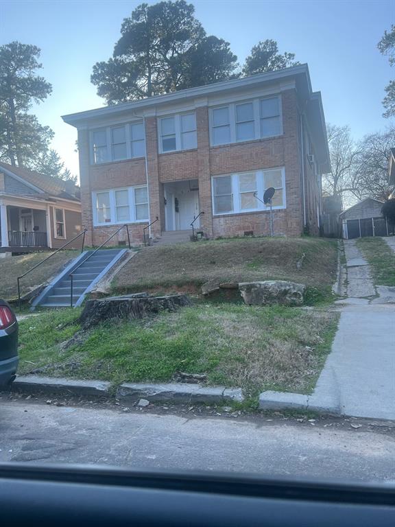 a front view of a house with a yard and a garage