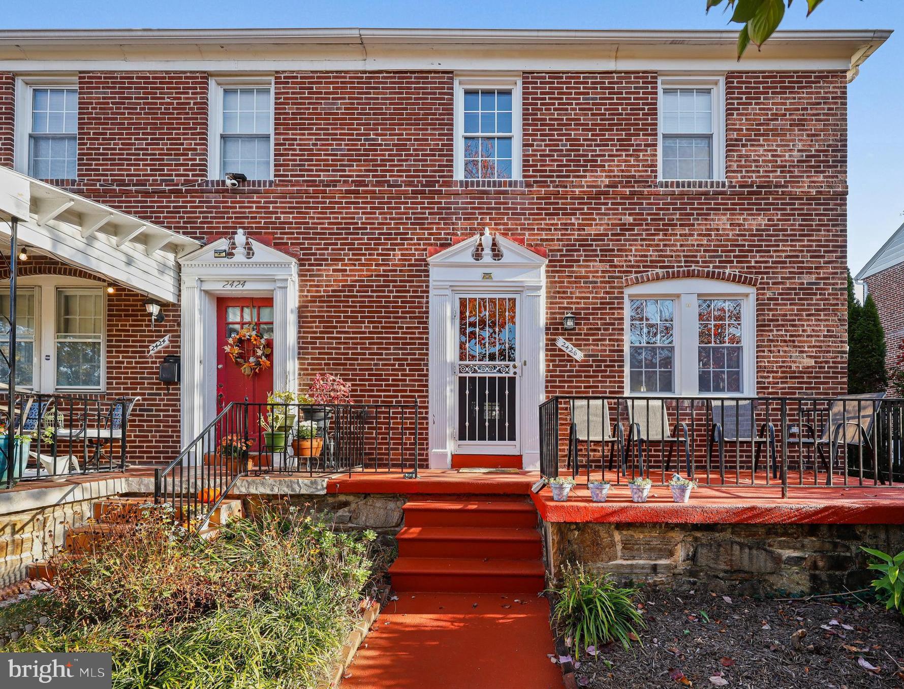 a front view of a house with outdoor seating