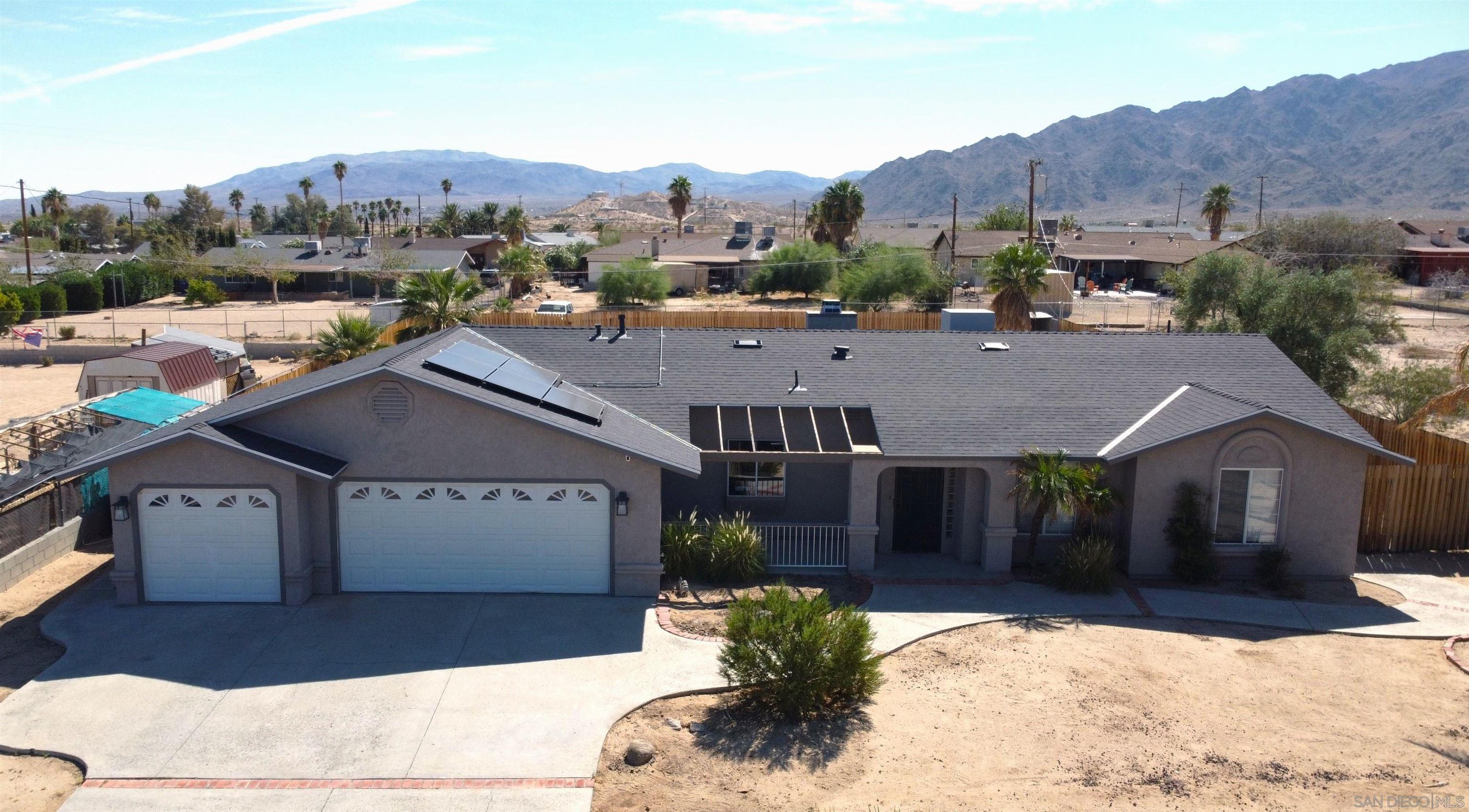 a aerial view of a house next to a road