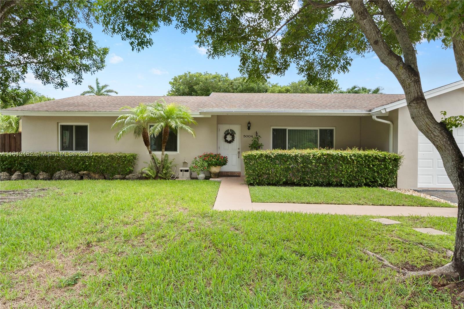 a front view of house with yard and green space