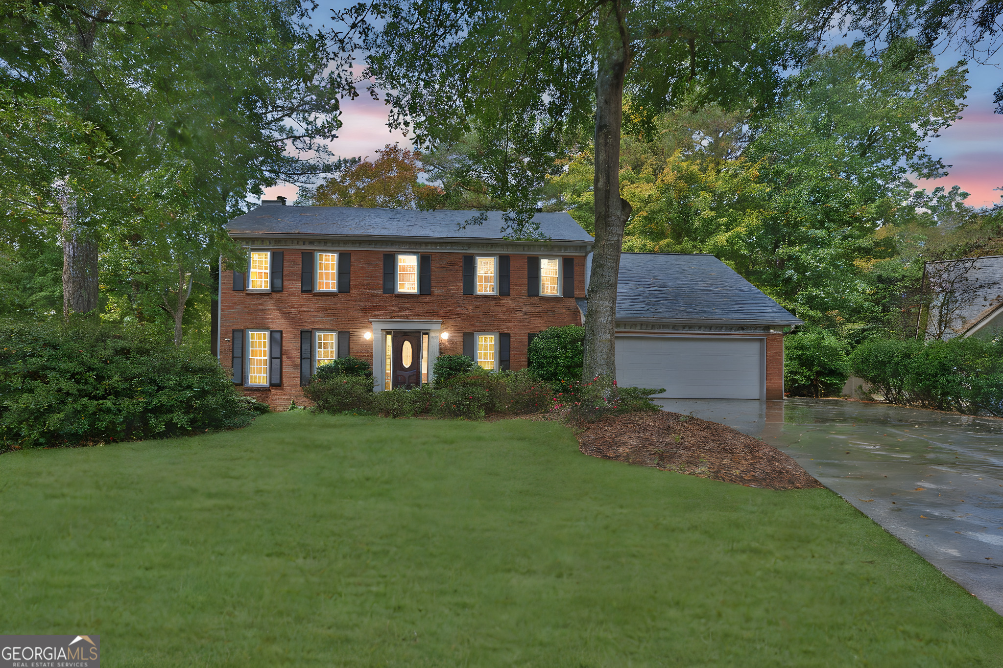 a front view of a house with a garden