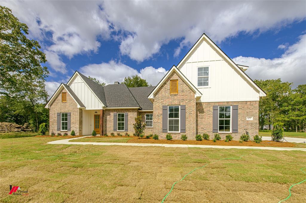 a front view of house with yard and swimming pool