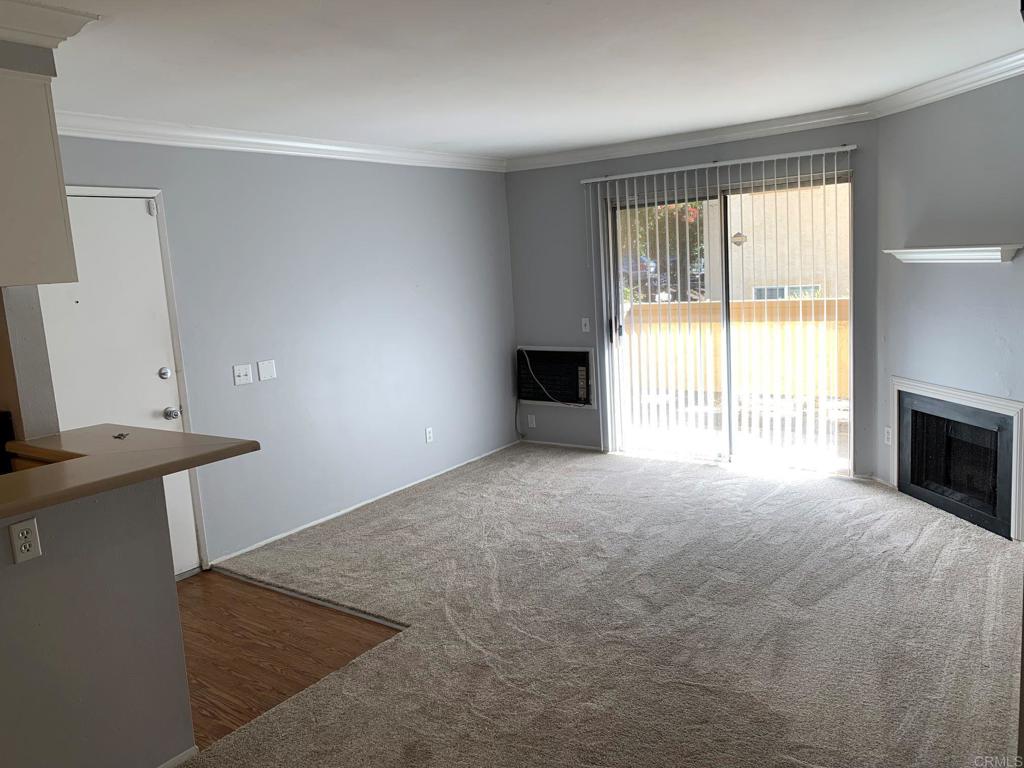 a view of an empty room with a fireplace