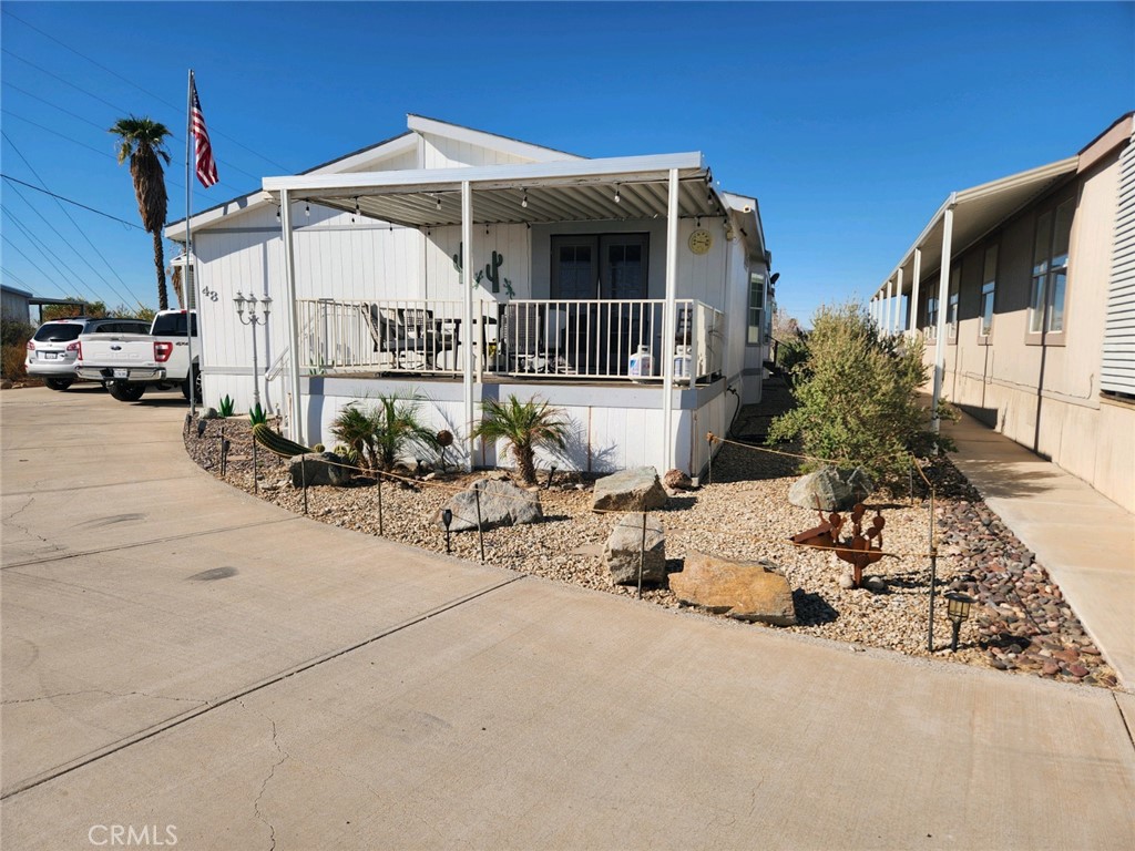 a view of a house with backyard and sitting area