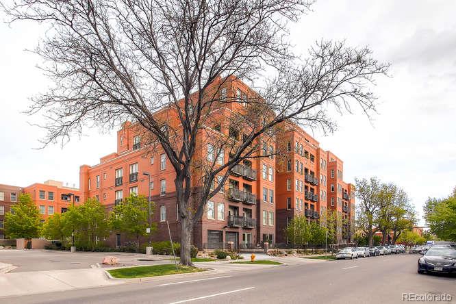 a view of a city street lined with buildings and trees