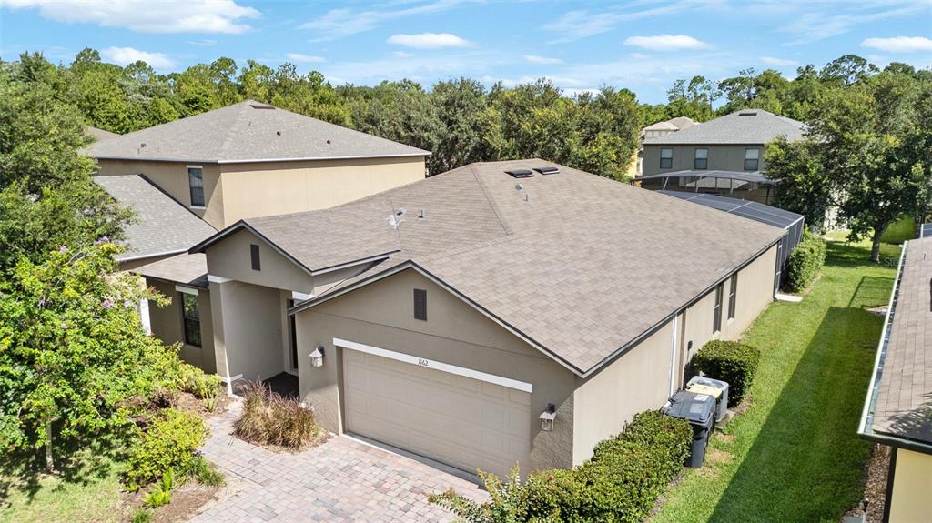 an aerial view of a house with a yard