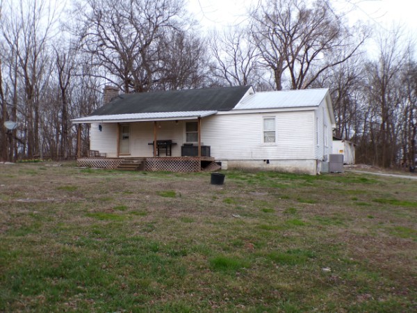 a front view of house with yard and trees