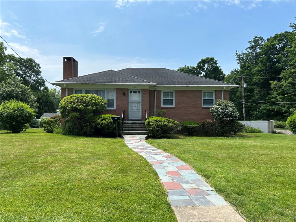 a front view of house with yard and green space