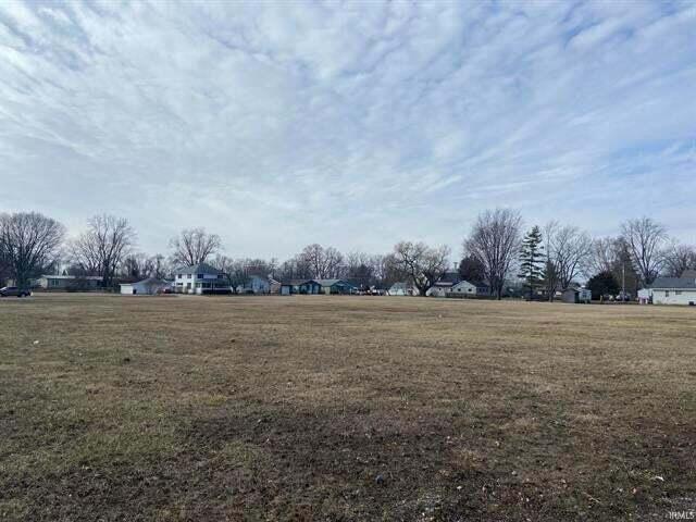 a view of a field with an trees