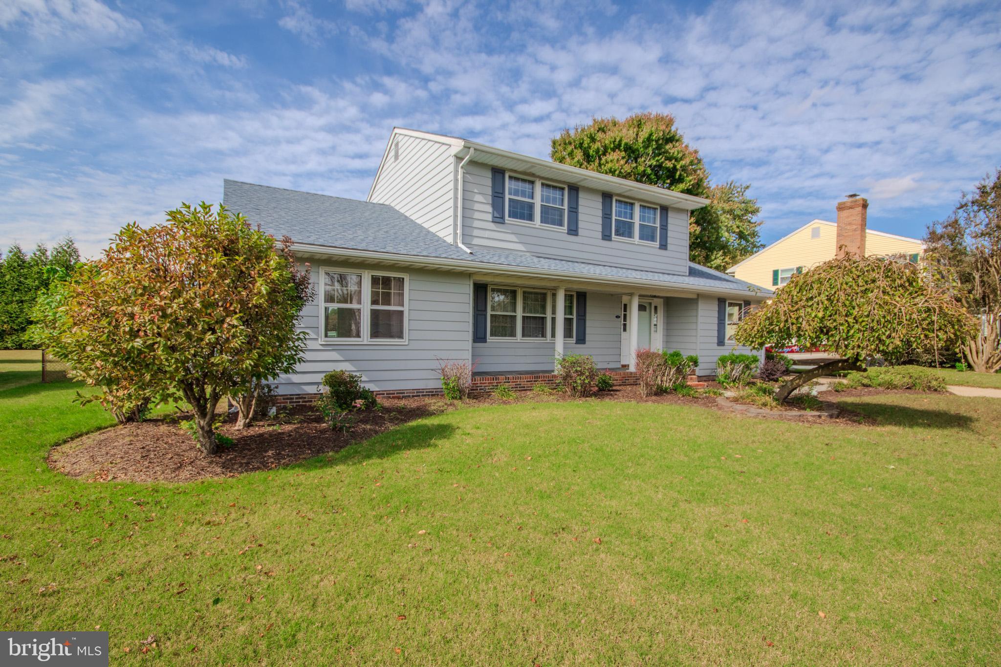 a view of a house with a yard patio and fire pit