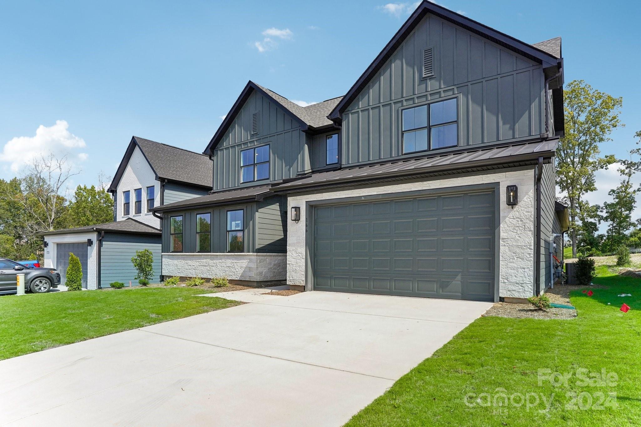 a view of a house with a yard and garage