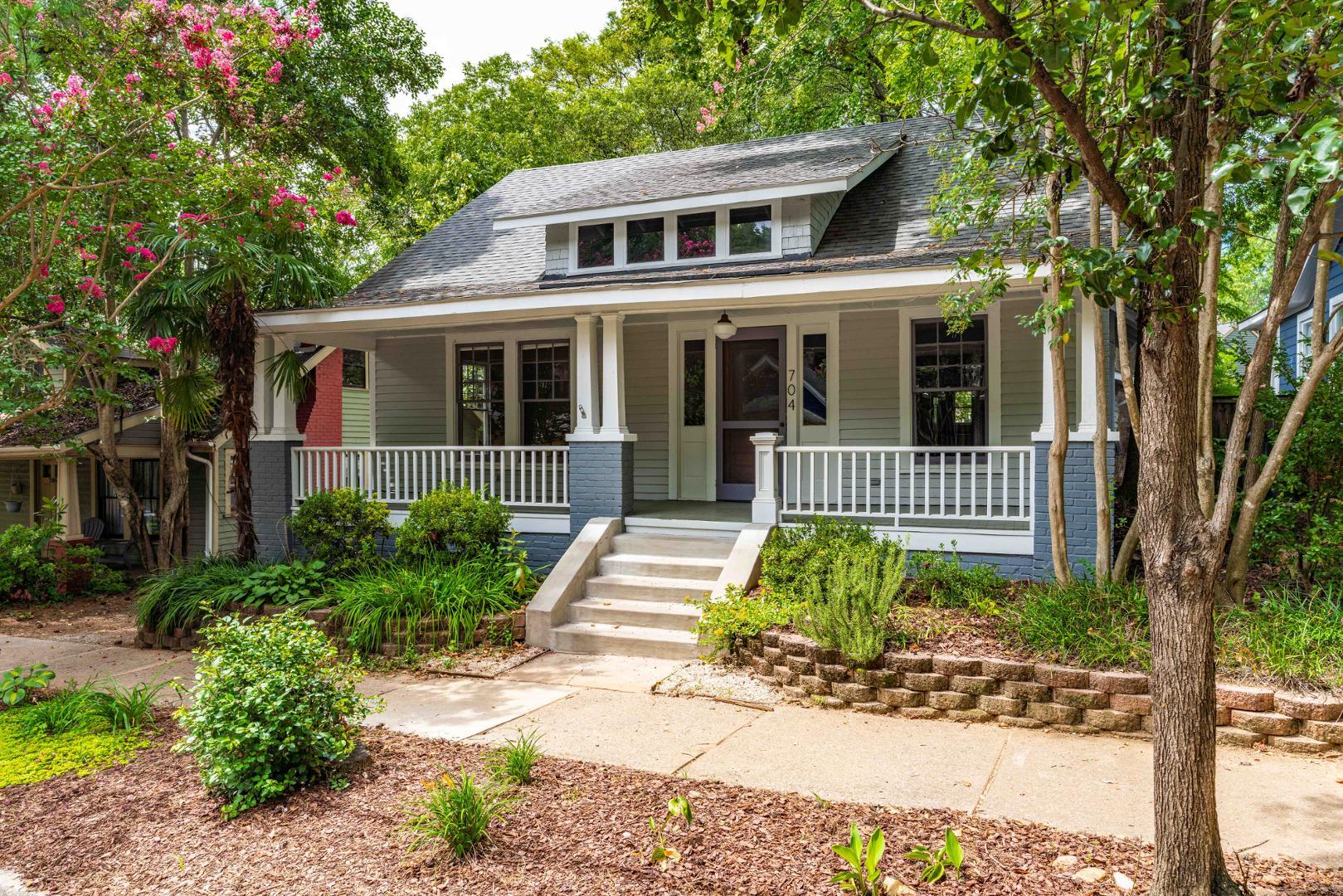 a front view of a house with a garden