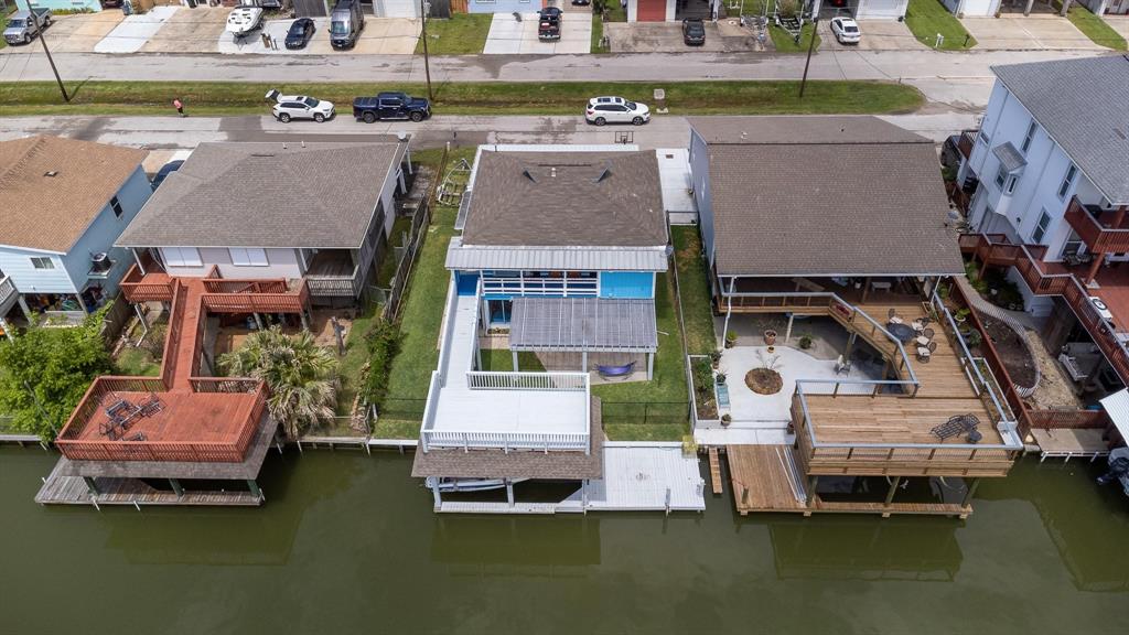 a aerial view of a house with a garden and lake view