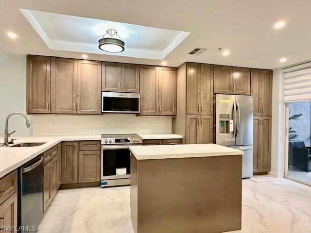 a kitchen with a sink a microwave and refrigerator