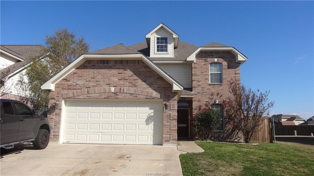 Front of property with a front yard and a garage