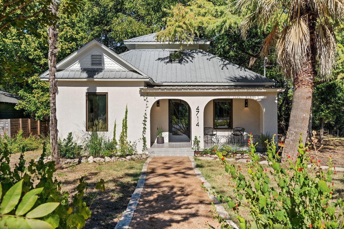 a front view of a house with garden