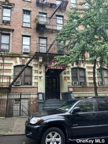 a front view of a house with parking space