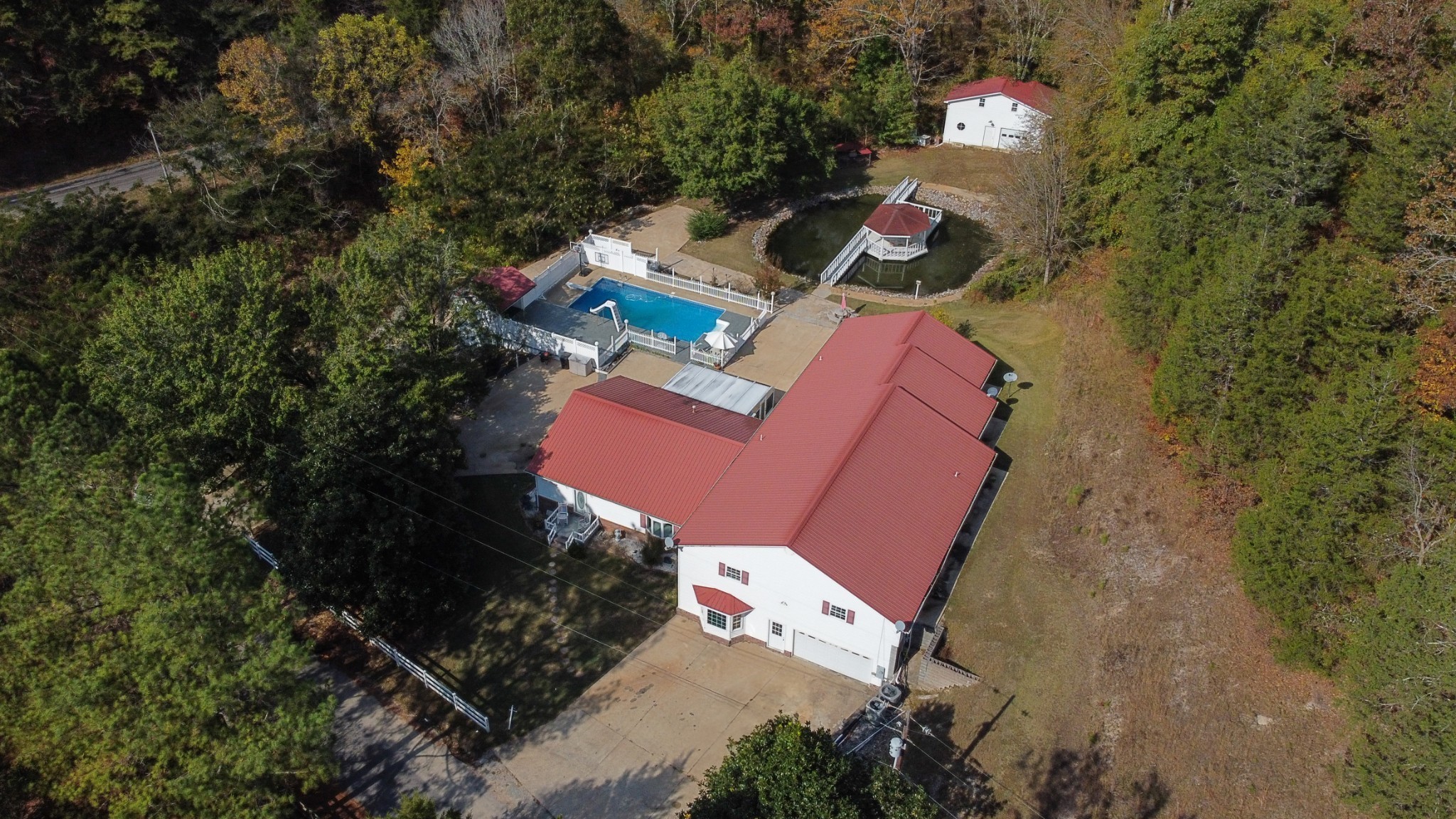 an aerial view of a house with a yard and trees