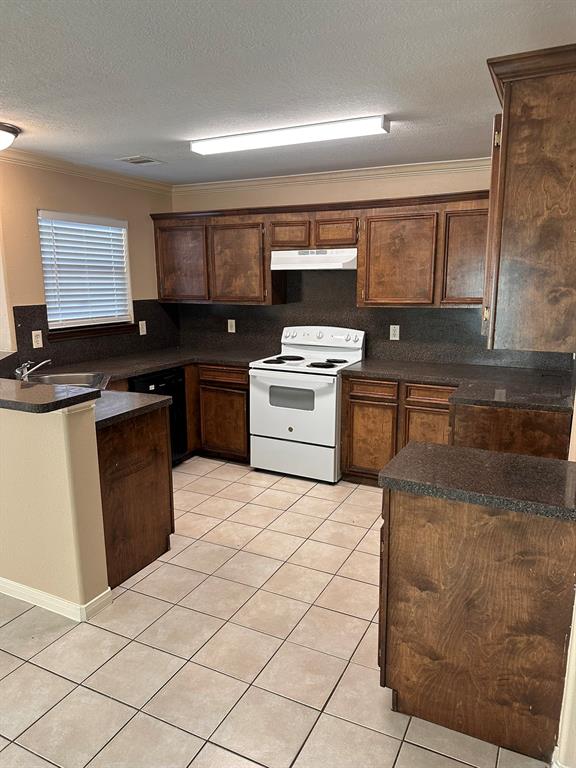 a kitchen with a stove top oven and cabinets