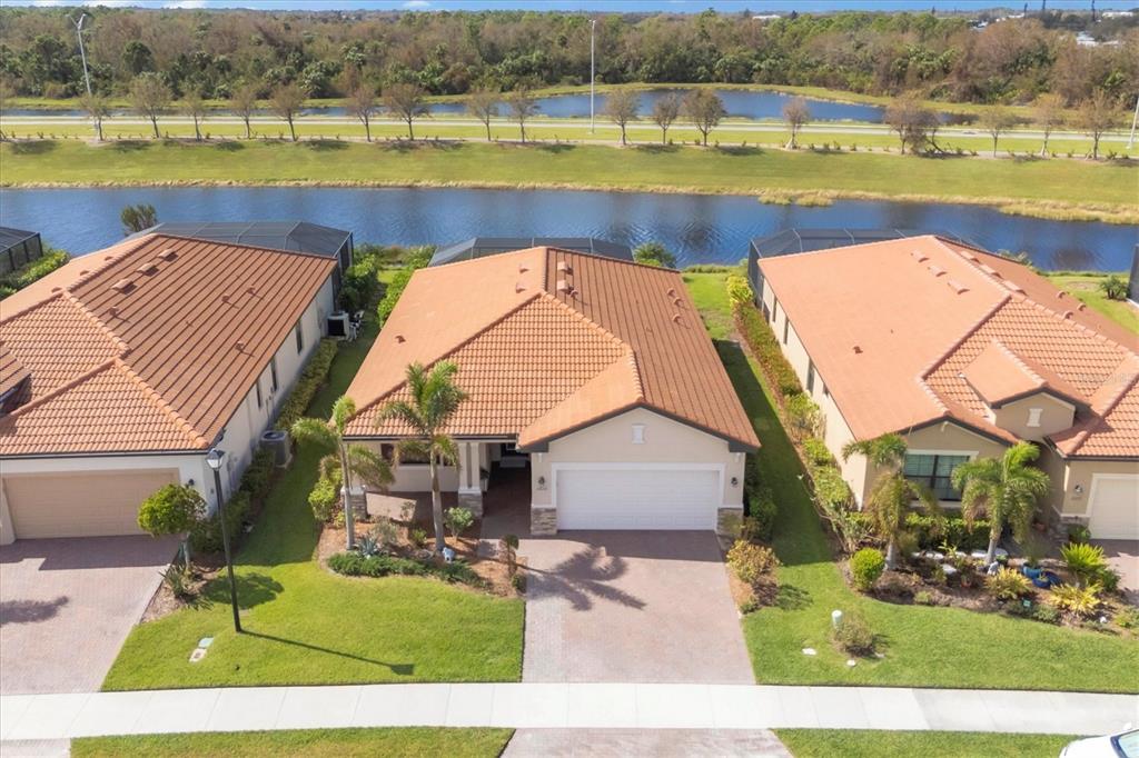 an aerial view of a house with a swimming pool and a yard