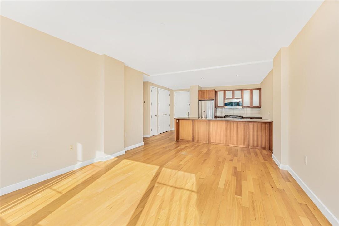 Unfurnished living room featuring light wood-type flooring