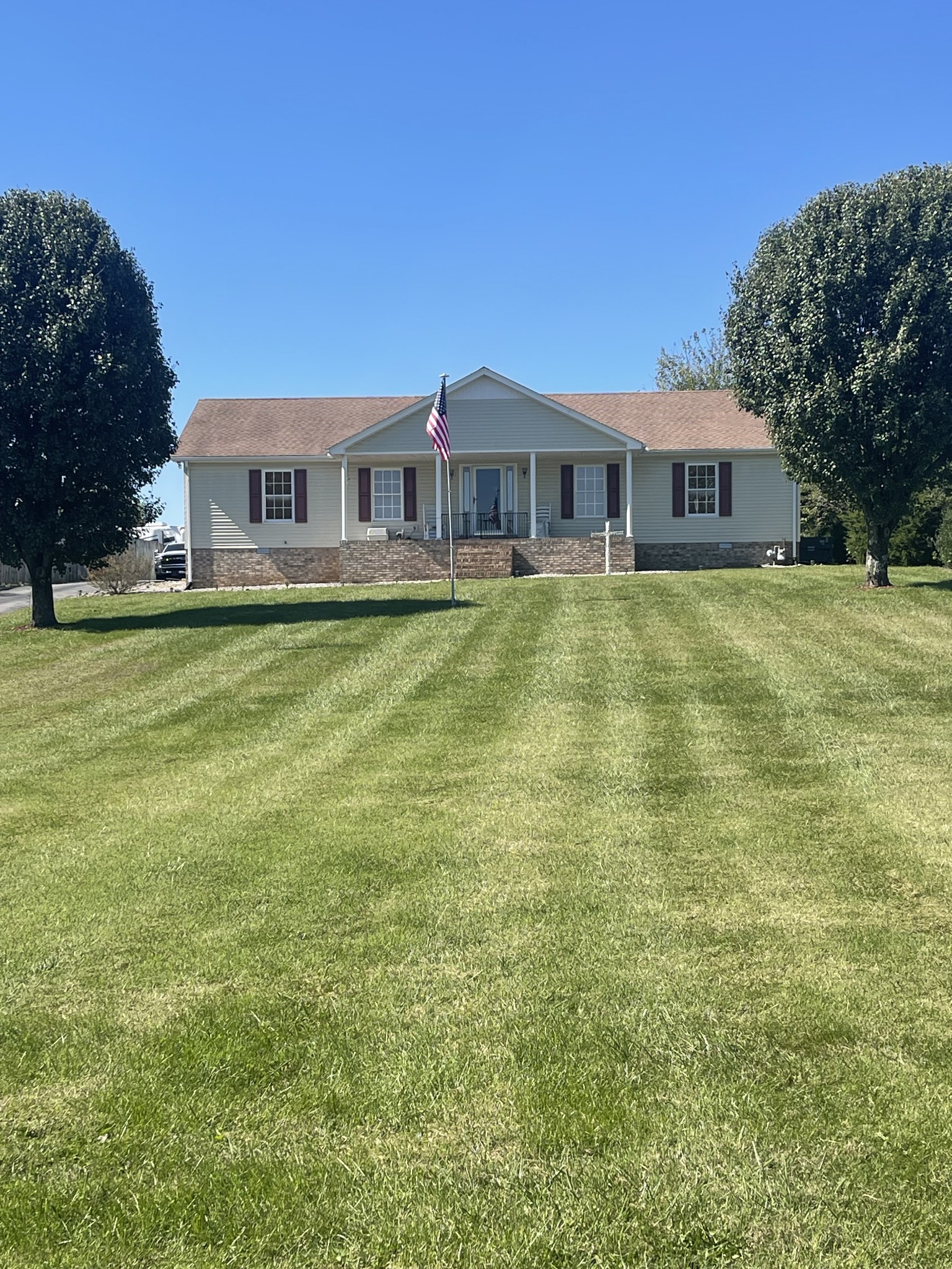 a front view of a house with a garden