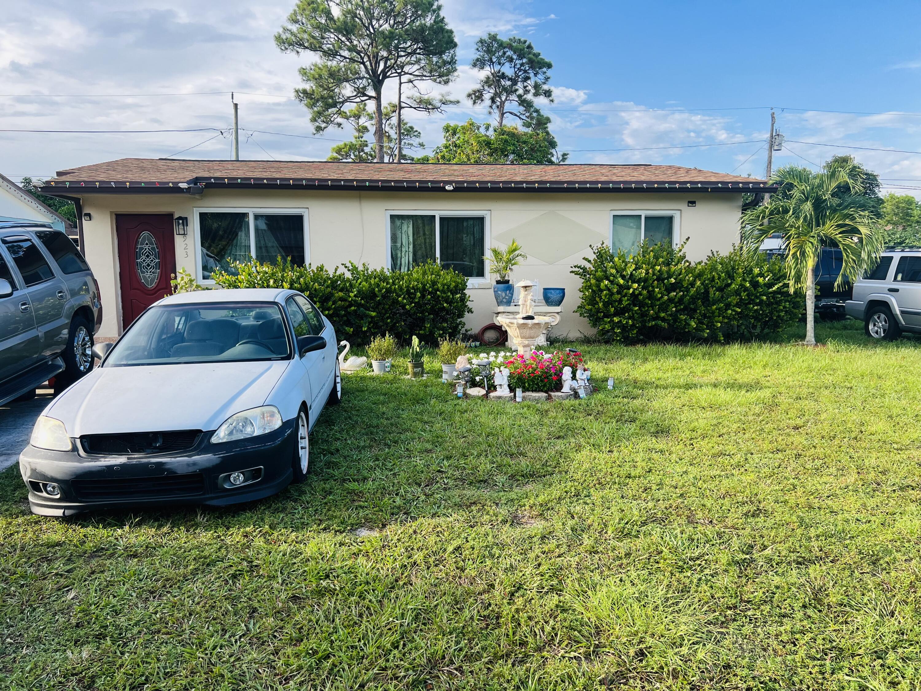 a view of a house with backyard sitting area and garden