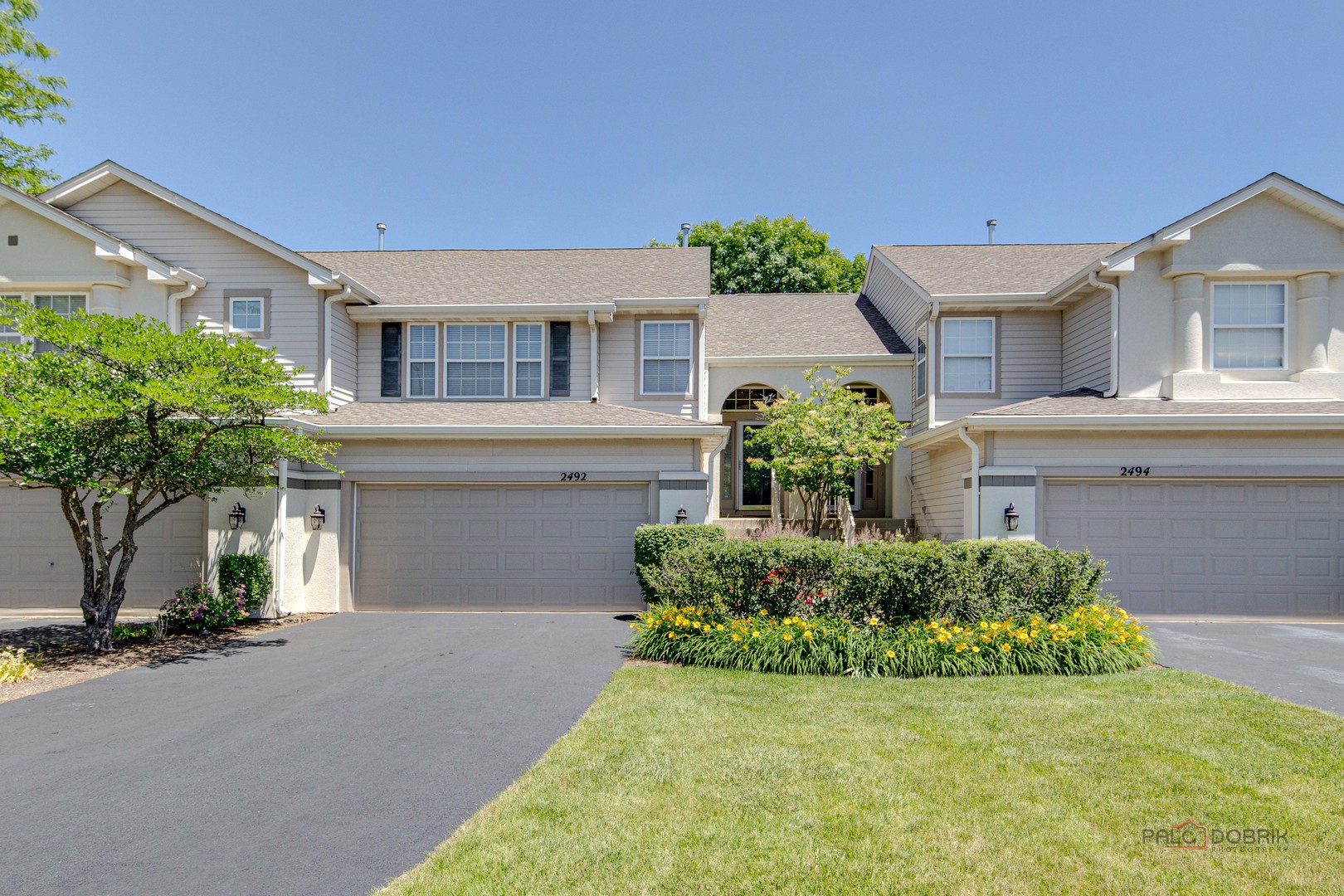 a front view of a house with a yard and garage